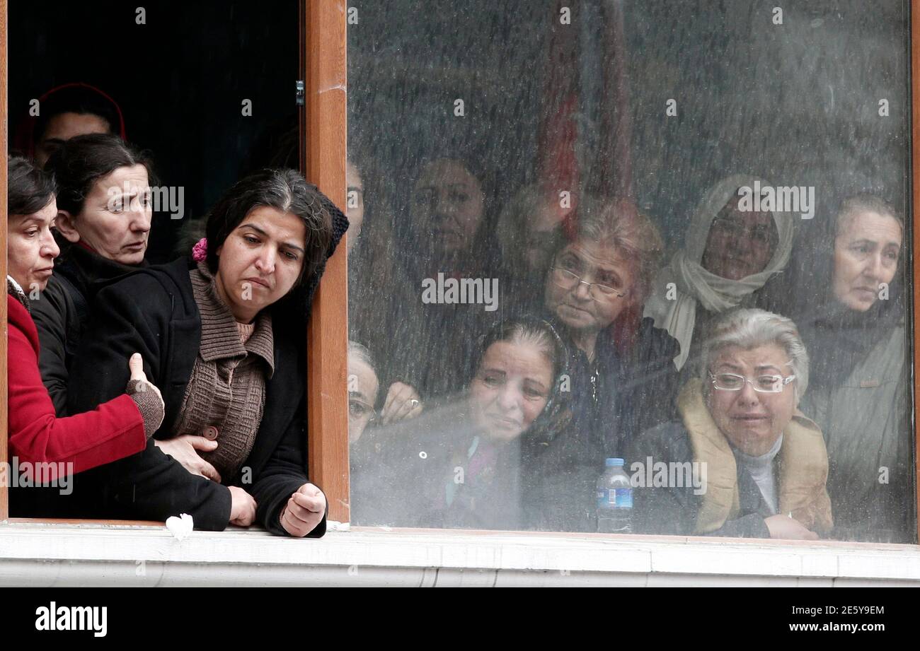 Mourning women including Berkin Elvan's mother Gulsum Elvan (3rd L) look out from Okmeydani cemevi in Istanbul March 11, 2014. Elvan, a 15-year-old Turkish boy who suffered a head injury during anti-government protests in Istanbul last June, died on Tuesday after spending months in a coma, triggering renewed clashes between police and his family's supporters. Berkin Elvan, then aged 14, got caught up in street battles between police and protesters on June 16 after going out to buy bread for his family. He was struck in the head with a suspected police tear-gas canister and went into a coma. RE Stock Photo