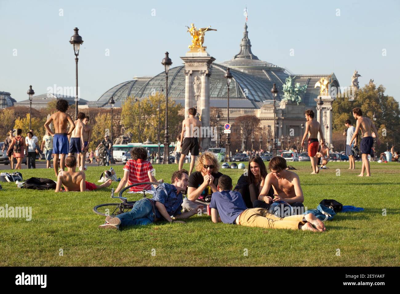 Young people on a lawn with the Grand Palais in the background. Stock Photo