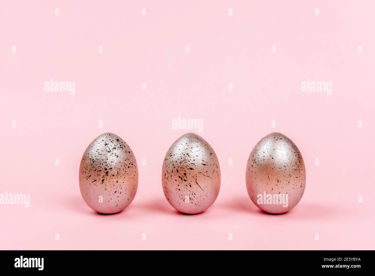 Easter eggs of silver colors with black dots on a pink background Stock Photo