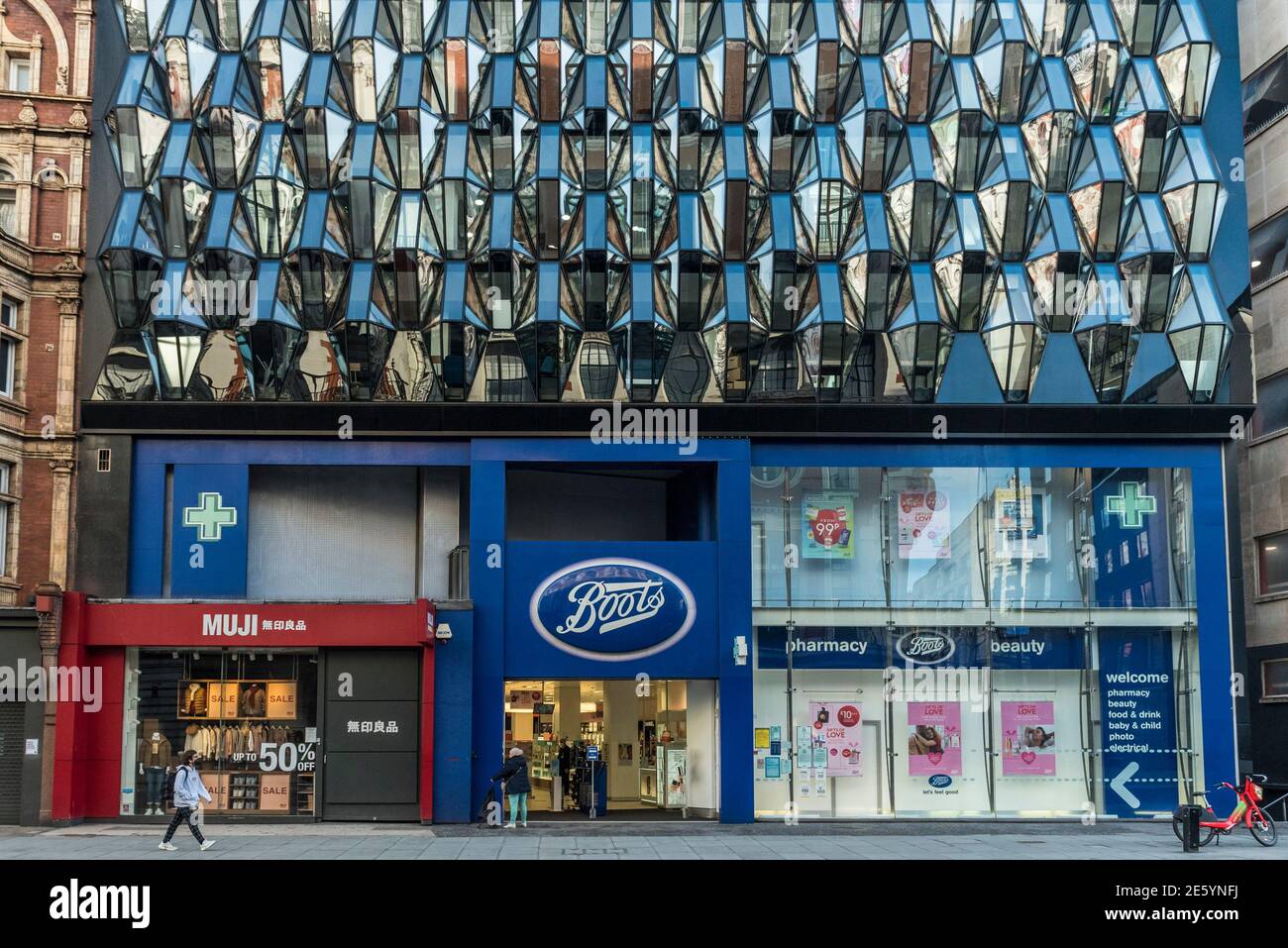 London, UK. 28 January 2021. Eye-catching architecture above a branch of  Boots pharmacy, an essential business, which is open for trading on Oxford  Street . Already suffering from competition from online shopping,