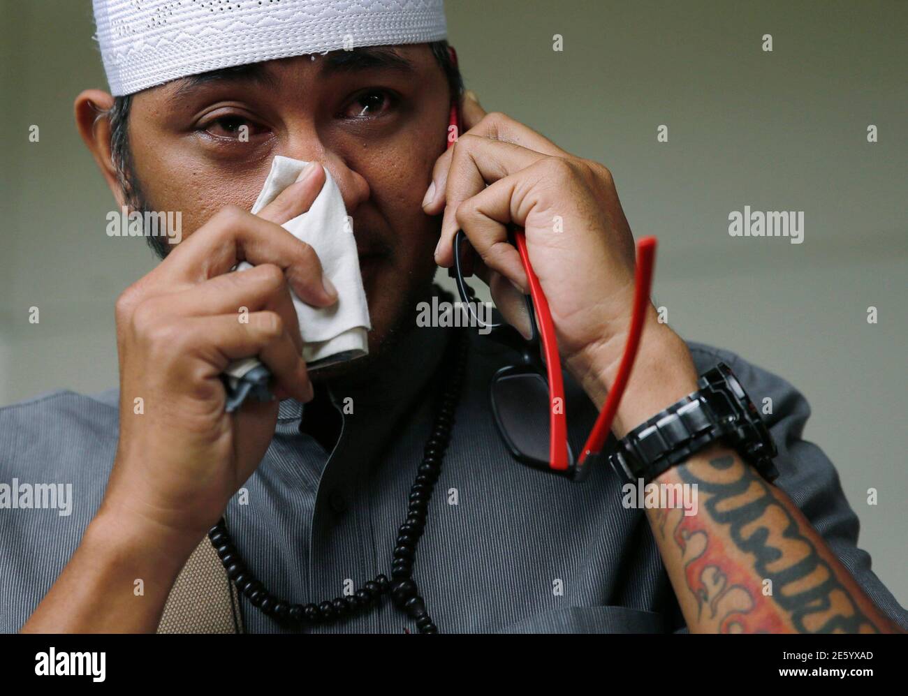 An Indonesian Man Whose Wife Is A Passenger Onboard The Missing Airasia Flight Qz8501 Makes A Phone Call At A Waiting Area In Juanda International Airport Surabaya December 29 2014 The Missing