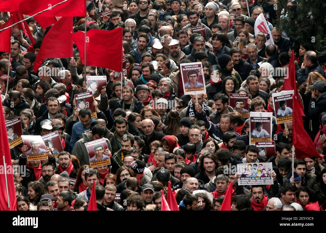Mourners carry posters of Berkin Elvan as they wait for his funeral ceremony in Okmeydani cemevi, an Alevi place of worship, in Istanbul March 12, 2014.  Several thousand mourners gathered in central Istanbul on Wednesday for the funeral of Elvan, a 15-year-old boy wounded during anti-government demonstrations last summer whose death on Tuesday triggered protests across Turkey.  REUTERS/Osman Orsal (TURKEY  - Tags: POLITICS CIVIL UNREST) Stock Photo
