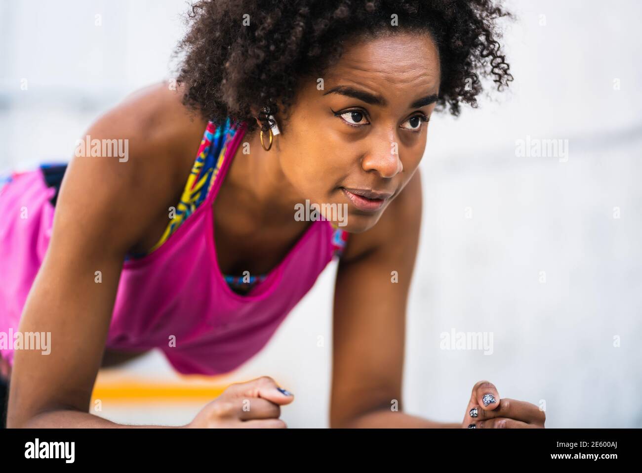 Afro athlete woman doing pushups outdoors. Stock Photo