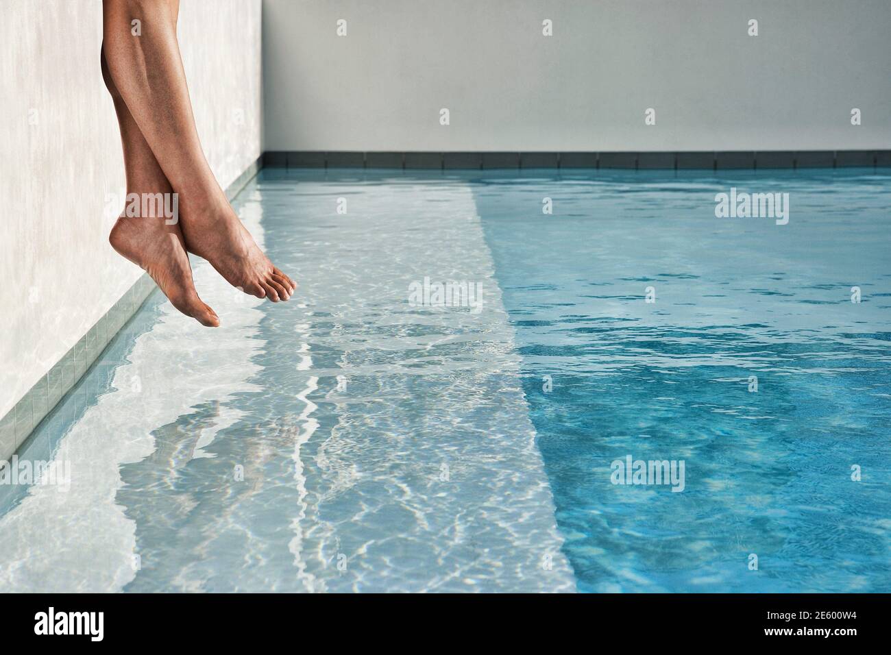 Cropped photo of Legs by Swimming Pool Stock Photo