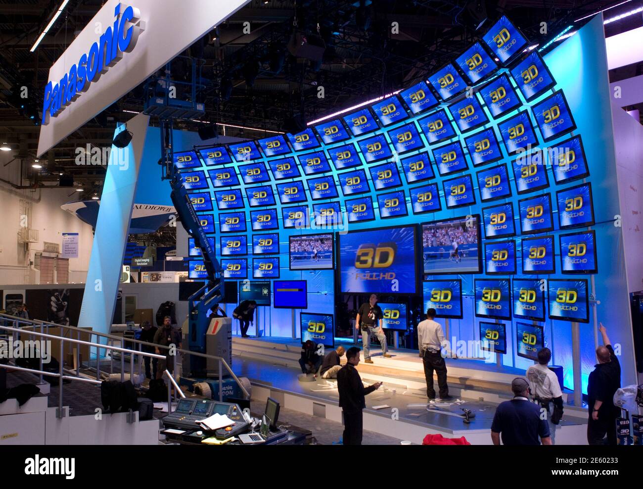 Workers in the Panasonic booth prepare for the 2011 International Consumer Electronics Show (CES) in Las Vegas, Nevada January 5, 2011. The annual Consumer Electronics Show in Las Vegas from Jan. 6-9, showcases the tablets, 3D- and Internet-enabled TVs expected to make the biggest splash in 2011. The battle for recession-weary consumers will pit Samsung Electronics, Sony Corp, LG Electronics, Google Inc, Netflix and Apple Inc against each other, all fighting to make their technology the standard.   REUTERS/Steve Marcus (UNITED STATES - Tags: BUSINESS) Stock Photo
