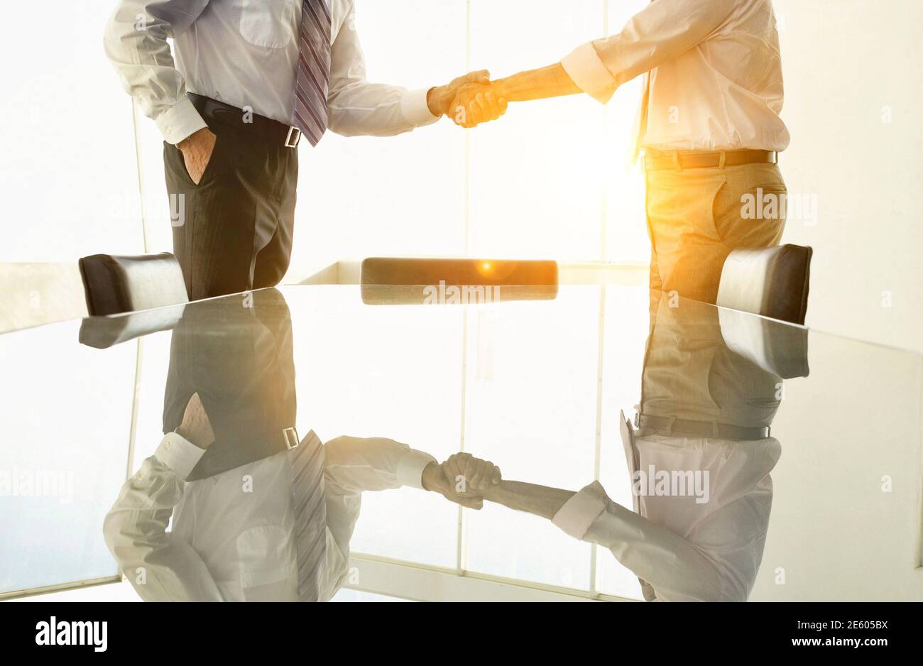 Midsection of business people shaking hands in conference room Stock Photo