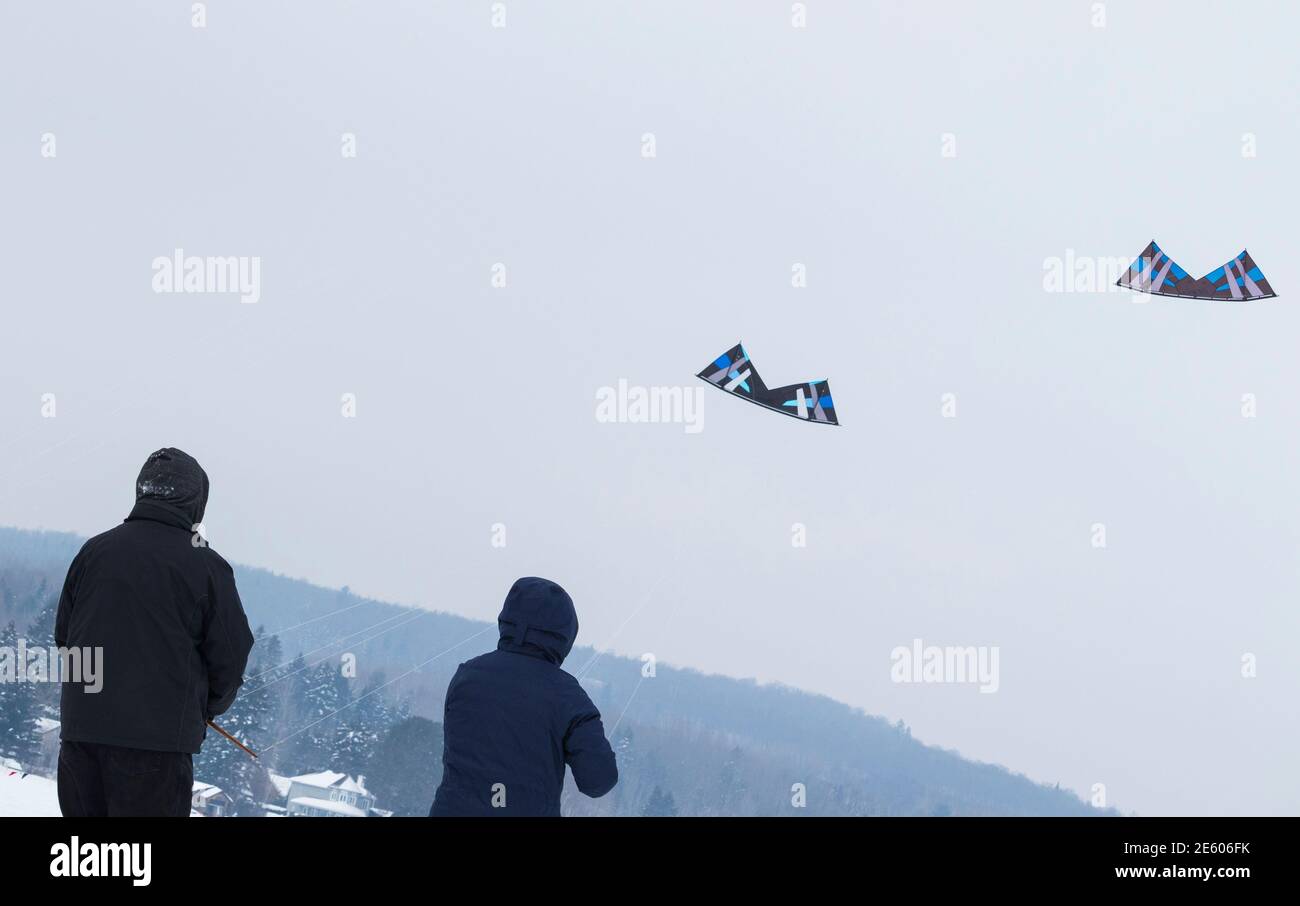 February 2, 2019 - Grandes-Piles, Qc, Canada: 2 people kiting during Kite Winter Festival (Festi-Volant) in Mauricie Stock Photo