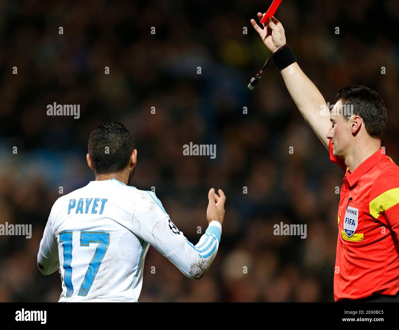 Referee Marijo Strahonja shows a red card to Olympique Marseille's Dimitri  Payet during their Champions League soccer match against Borussia Dortmund  at the Velodrome stadium in Marseille, December 11, 2013. REUTERS/Jean-Paul  Pelissier (