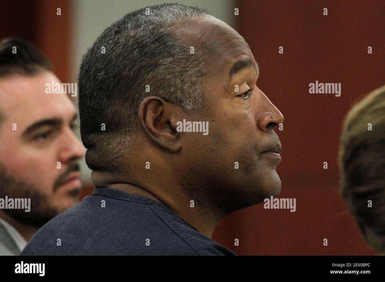 O.J. Simpson listens to testimony at an evidentiary hearing in Clark County District Court in Las Vegas, Nevada May 16, 2013. O.J. Simpson, the former football star famously acquitted of murder in 1995, took the witness stand in a Las Vegas courtroom on Wednesday seeking a new trial in an armed-robbery case that sent him to prison five years ago.    REUTERS/Steve Marcus    (UNITED STATES  - Tags: CRIME LAW ENTERTAINMENT SPORT) Stock Photo