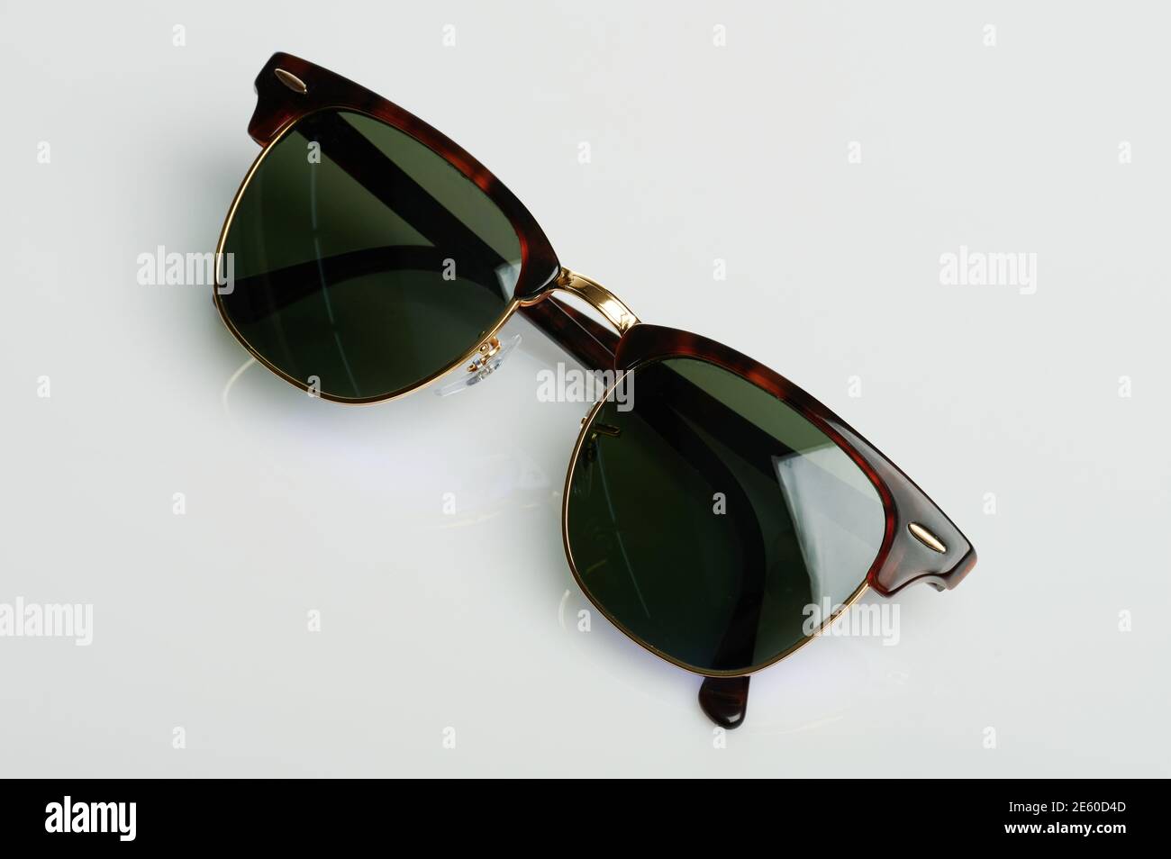 Folded sunglasses with dark lens isolated on white studio background ...