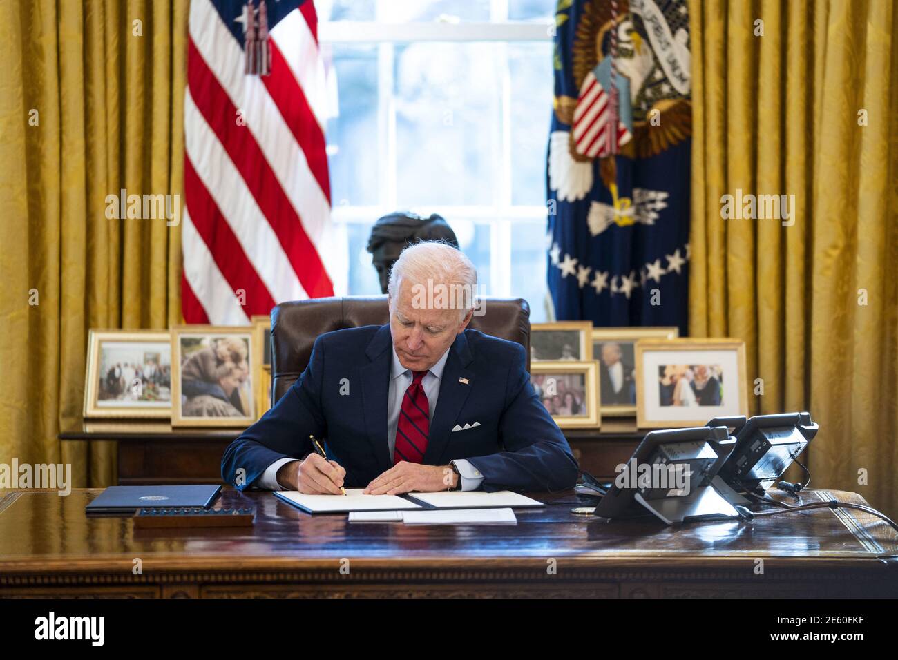 President Joe Biden signs executive actions strengthening AmericansâÂ€Â™ access to quality, affordable health care, in the Oval Office, Thursday, Jan. 26, 2021. (Photo by Doug Mills/The New York Times) Stock Photo
