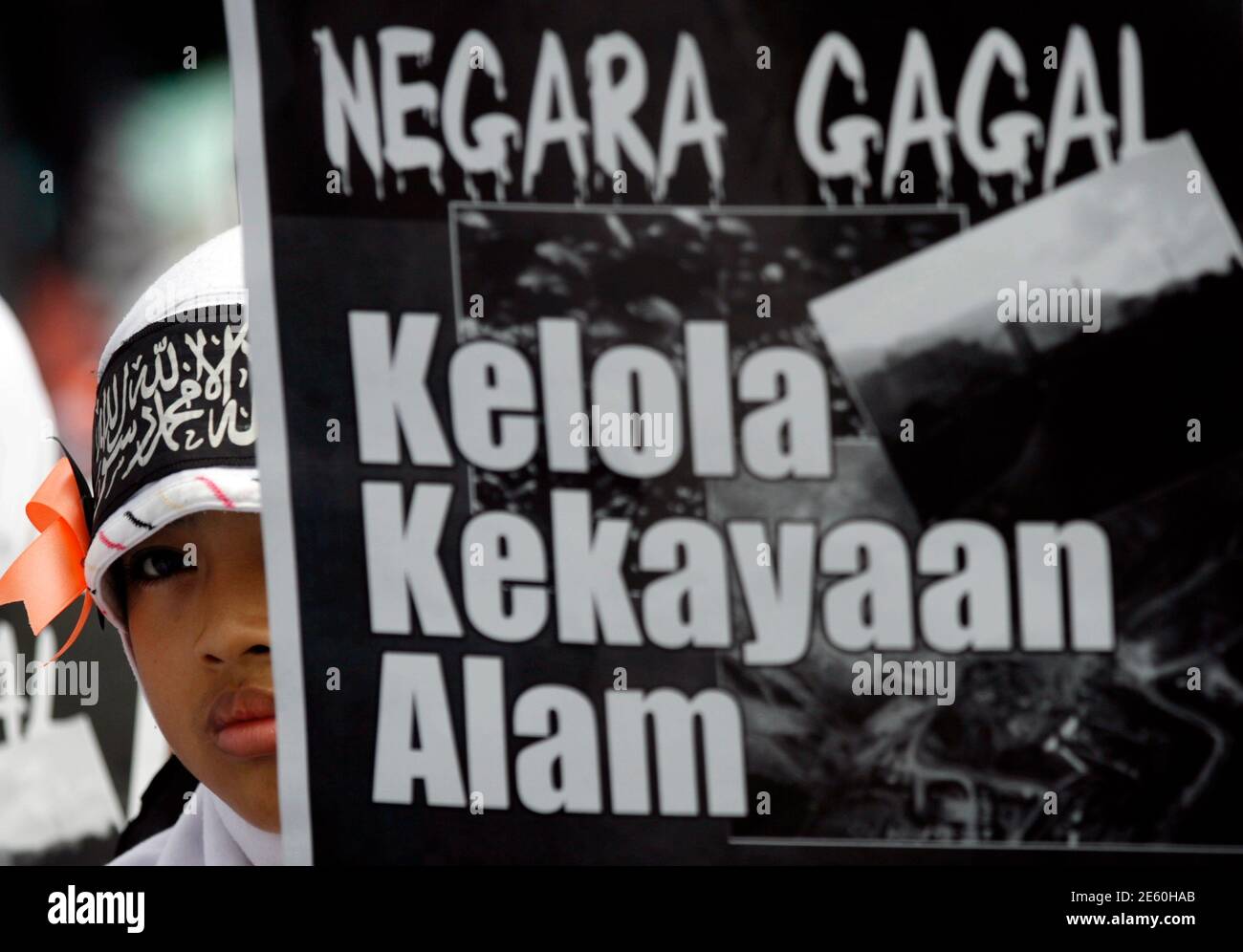 A Member Of The Islamist Organisation Hizbut Tahrir Holds A Placard That Reads State Fails To Manage Natural Resources During A Rally In Front Of The Presidential Palace In Jakarta January 23<script async src=