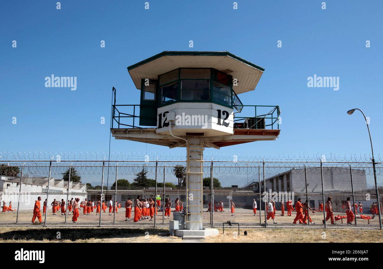 Inmates walk around an exercise yard at the California Institution for Men state prison in Chino, California, June 3, 2011. The Supreme Court has ordered California to release more than 30,000 inmates over the next two years or take other steps to ease overcrowding in its prisons to prevent 'needless suffering and death.' California's 33 adult prisons were designed to hold about 80,000 inmates and now have about 145,000. The United States has more than 2 million people in state and local prisons. It has long had the highest incarceration rate in the world. REUTERS/Lucy Nicholson (UNITED STATES Stock Photo