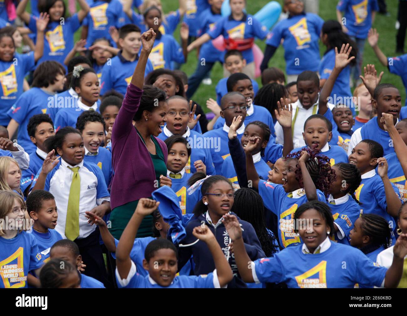 U.S. first lady Michelle Obama greets children at an event on the South Lawn of the White House in Washington October 11, 2011 to launch a challenge to help break the Guinness World Records title for the most people doing jumping jacks in a 24-hour period. To break the record, more than 20,000 people from around the world must perform jumping jacks for one minute. REUTERS/Yuri Gripas (UNITED STATES - Tags: POLITICS) Stock Photo