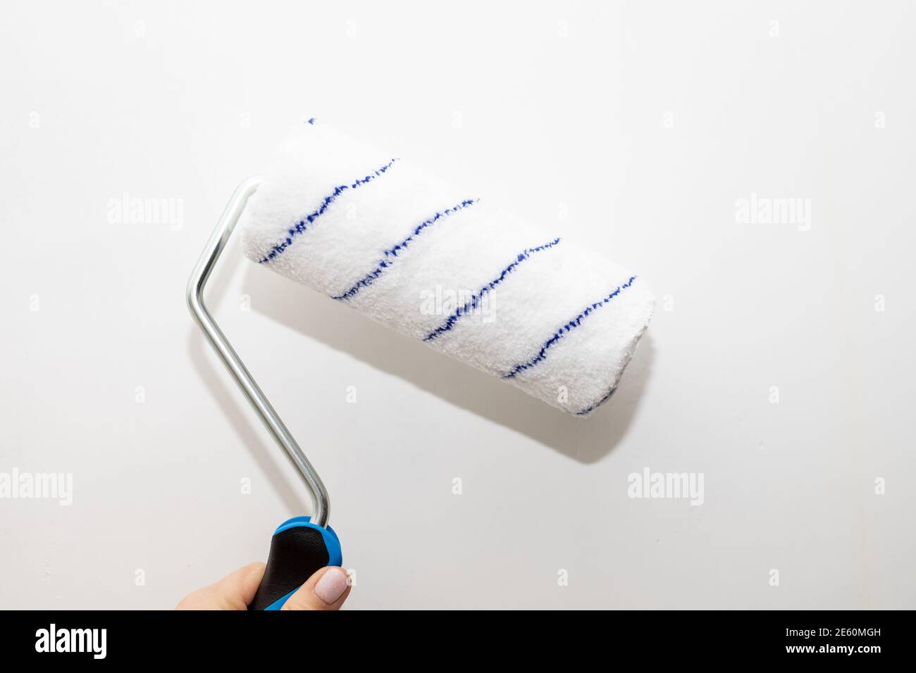 male hand with a roller for painting walls. The painter applies decorative  paint to the wall.repair inside the house.Roller Wall Painting. Worker  Stock Photo - Alamy