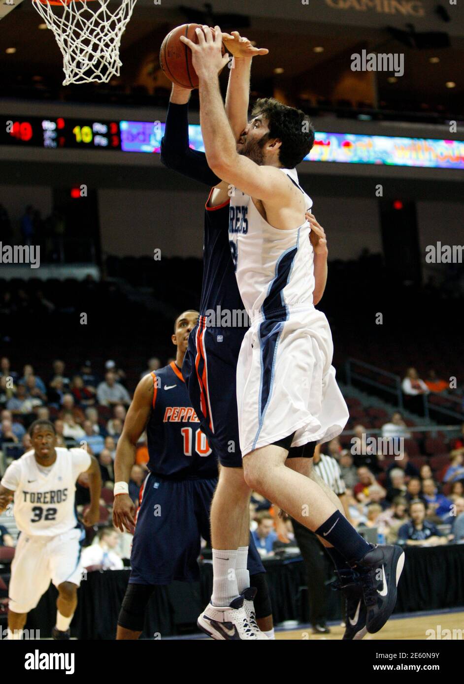 San Diego Toreros' Chris Manresa (R) is fouled by Pepperdine Waves' Corbin Moore during their West Coast Conference Championships basketball game at the Orleans Arena in Las Vegas, Nevada March 1, 2012.  REUTERS/Steve Marcus (UNITED STATES - Tags: SPORT BASKETBALL) Stock Photo