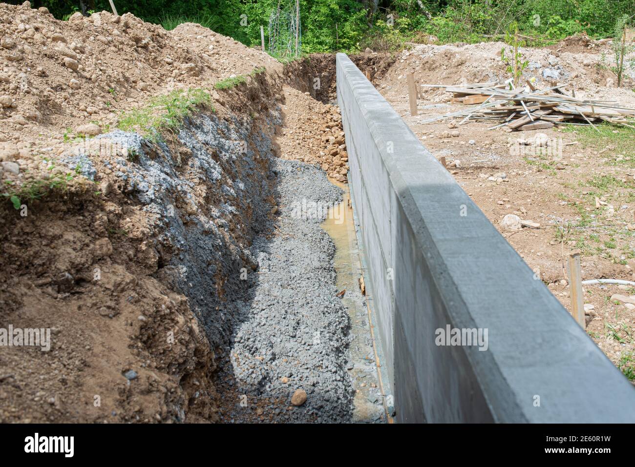 Construction shaft by a concrete wall as a border between two