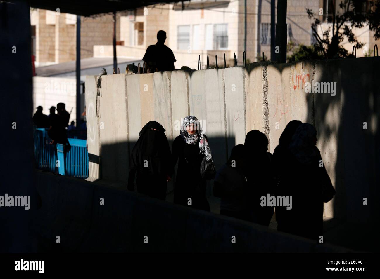 Palestinian women cross at an Israeli checkpoint in the West Bank town of Bethlehem, during the holy month of Ramadan July 26, 2013. REUTERS/Baz Ratner (WEST BANK - Tags: POLITICS RELIGION SOCIETY) Stock Photo