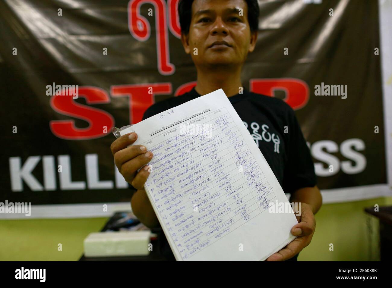 A reporter shows signatures they collected in support of the freedom press law in the Myanmar Journalist Network office in Yangon September 3, 2013. The junta is gone, but the Electronic Transactions Law and other draconian legislation remain on Myanmar's books. Attempts to revamp them are stirring debate over the reformist credentials of the semi-civilian government that took power in 2011 and how far it will loosen tough state controls. Picture taken September 3, 2013.   To match Feature MYANMAR-LAWS/    REUTERS/Soe Zeya Tun (MYANMAR - Tags: POLITICS CRIME LAW MEDIA) Stock Photo