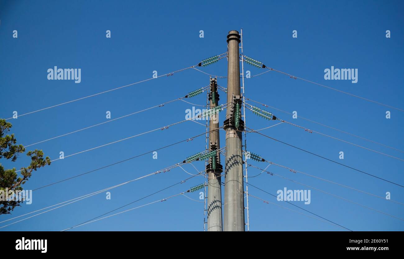 High voltage power lines on deep blue sky background Stock Photo - Alamy
