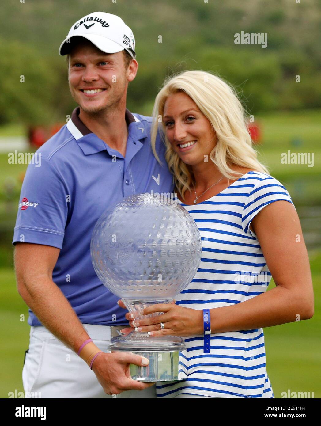 Danny Willett (L) of England poses with the trophy after winning the  Nedbank Challenge at Sun City December 7, 2014. Briton Willett landed six  birdies and the biggest win of his career