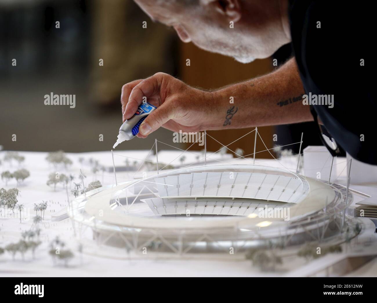 Architect Dan Meis puts some finishing touches on a model as San Diego's Citizens Stadium Advisory Group unveils their plan for building a new $1.1 billion NFL football stadium in San Diego, California May 18, 2015. The San Diego Chargers have announced plans to leave the city unless they can come to terms on the building of a new stadium.     REUTERS/Mike Blake Stock Photo