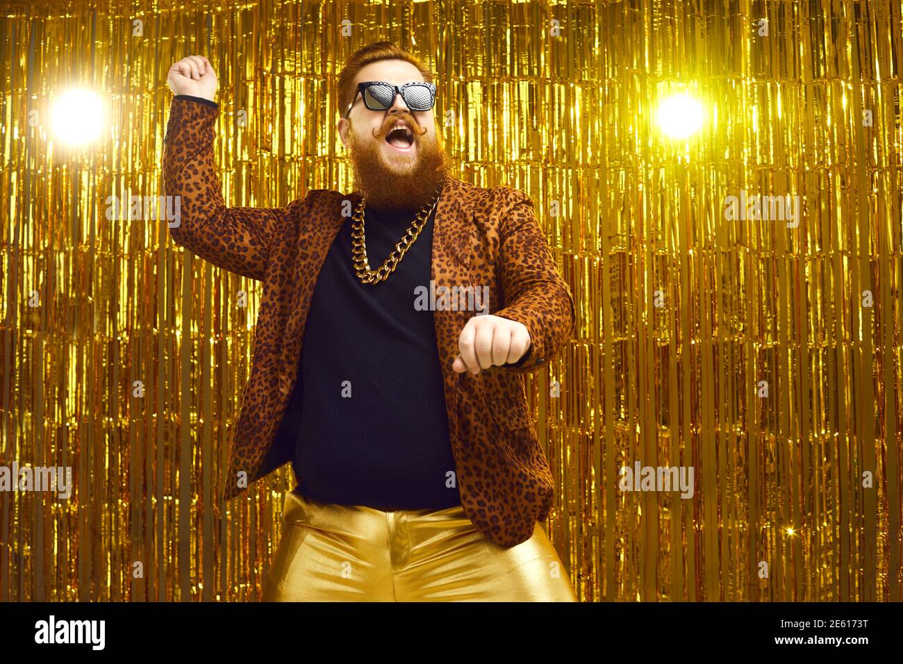 Happy bearded man in crazy outfit dancing gangnam style and having fun at a party Stock Photo