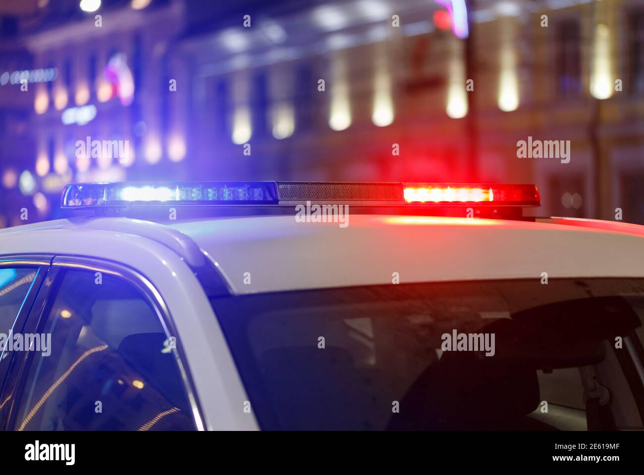 abstract night police car lights in city with selective focus and bokeh blur Stock Photo