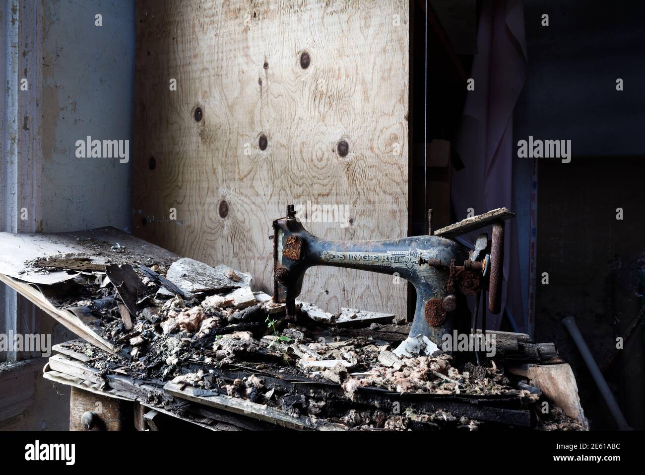 A rusty vintage Singer sewing machine left to rot inside an abandoned house. Ontario, Canada. Stock Photo