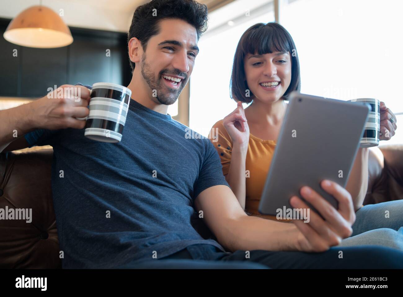 Couple on a video call with digital tablet at home. Stock Photo