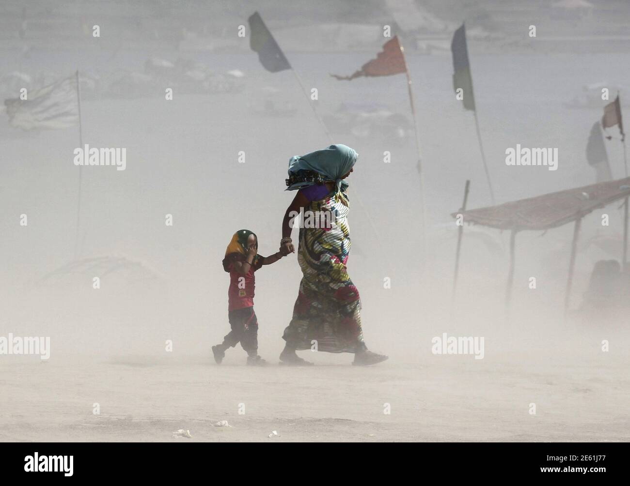 A Girl Covers Her Eyes As She Walks With Her Mother On The Banks Of The Ganges River During A Dust Storm On A Hot Summer Day In Allahabad India June 9 A Girl Covers Her Eyes As She Walks With Her Mother On The Banks Of The Ganges River During A Dust Storm On A Hot Summer Day In Allahabad India June 9