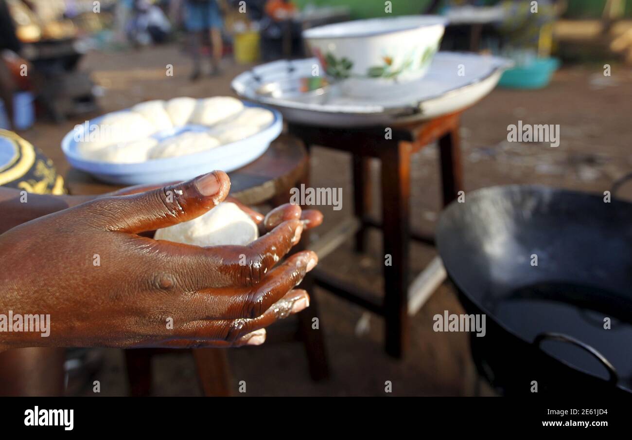 Florence Adhiambo Goro, a vendor prepared doughnuts at the trading centre of the U.S. President Barack Obama's ancestral village of Nyang'oma Kogelo, west of Kenya's capital Nairobi, July 14, 2015. Goro 37, said we are in business and Obama's visit is a direct boost to our economy. 'With President Obama's visit, we will celebrate and invite all his guests to spend time with us' she said. President Obama visits Kenya and Ethiopia in July, his third major trip to Sub-Saharan Africa after travelling to Ghana in 2009 and to Tanzania, Senegal and South Africa in 2011. He has also visited Egypt, in  Stock Photo