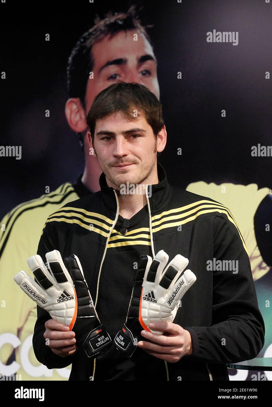 Real Madrid goalkeeper Iker Casillas poses with a pair of new gloves during  the unveiling of his Adidas sponsorship at Santiago Bernabeu stadium in  Madrid January 12, 2012. REUTERS/Andrea Comas (SPAIN -