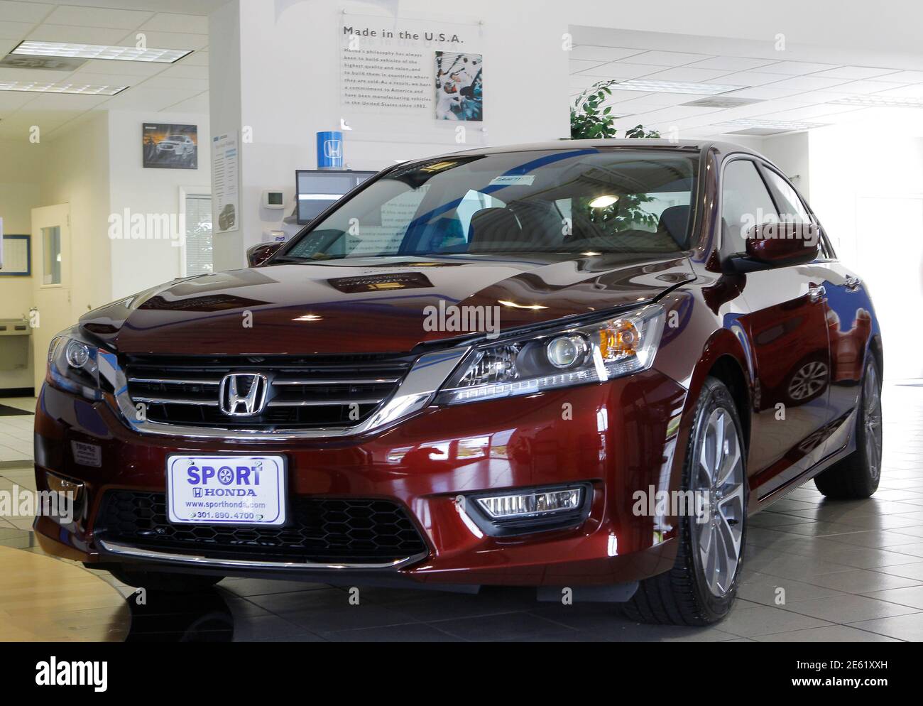 A new 2013 Honda Accord is shown on the sales floor at Sport Honda 