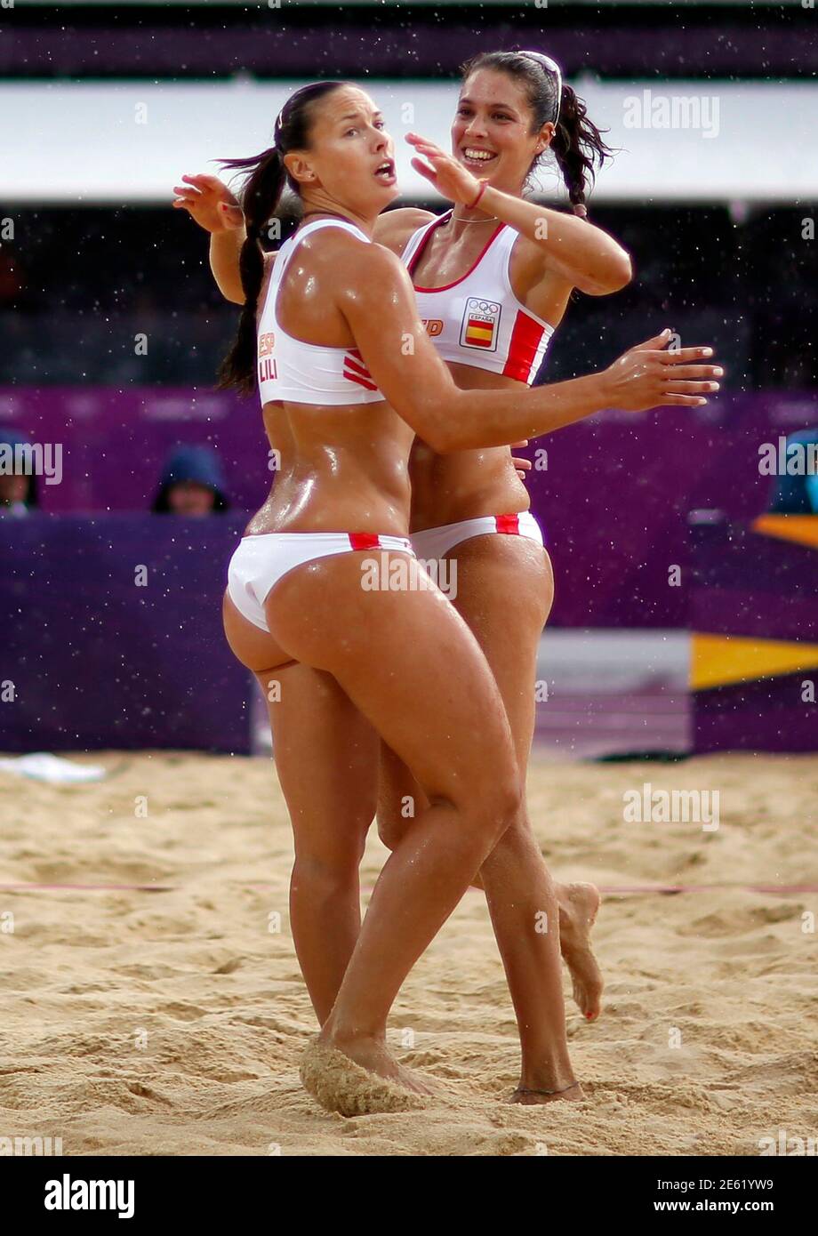 Spain's Liliana Fernandez Steiner and teammate Elsa Baquerizo McMillan (R)  celebrate a point during their women's beach volleyball preliminary round  match against the Netherlands at the London 2012 Olympics Games at the