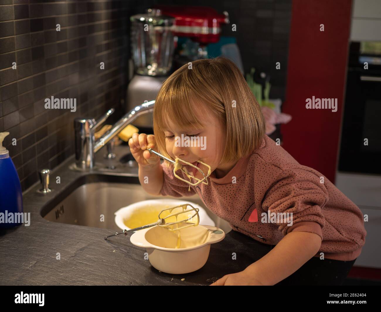 Little girl baking with her mother Stock Photo