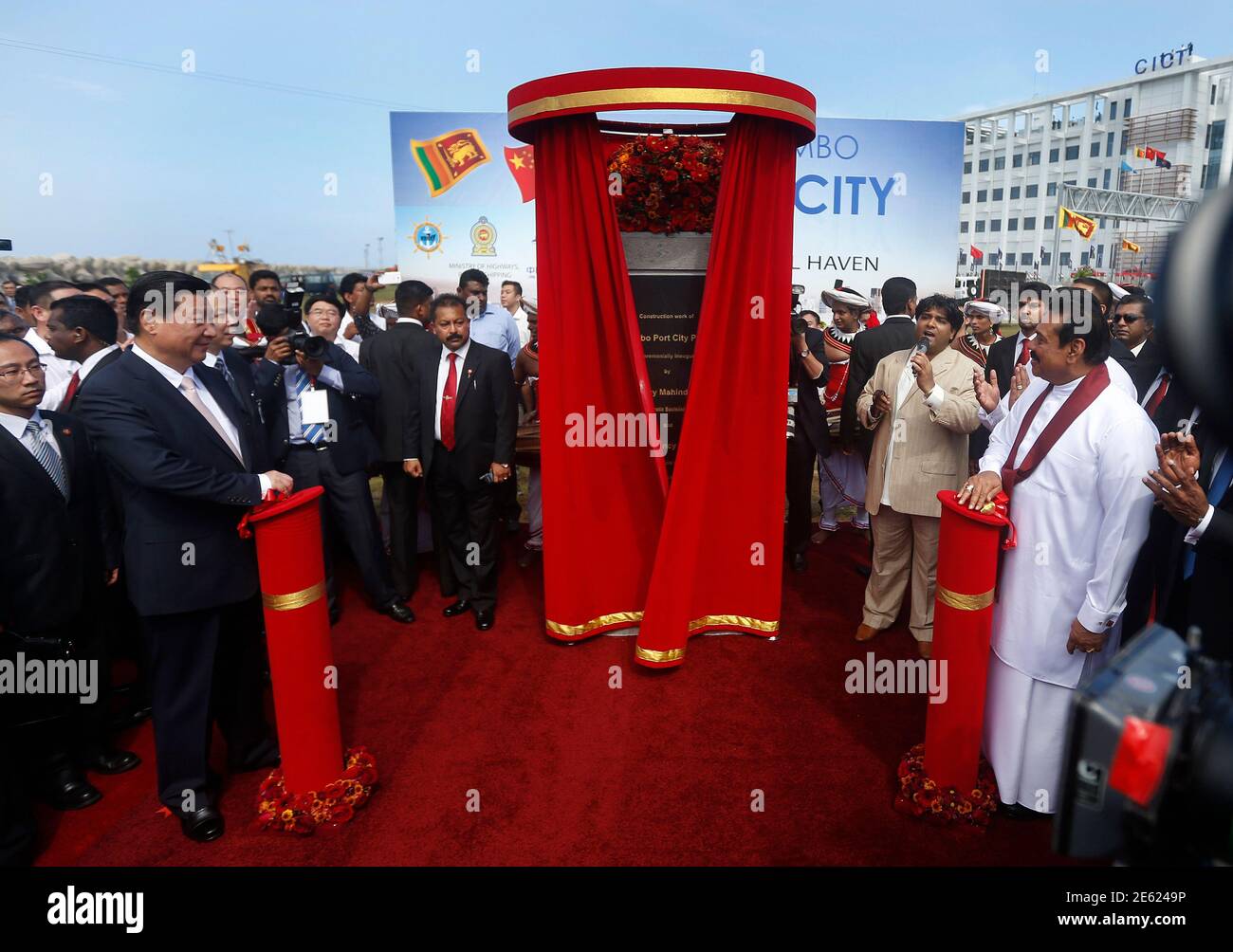 China's President Xi Jinping (2nd L) and Sri Lanka's President Mahinda  Rajapaksa (R) unveil a plaque during the launch ceremony of a $1.5 billion  project to build a port city on reclaimed