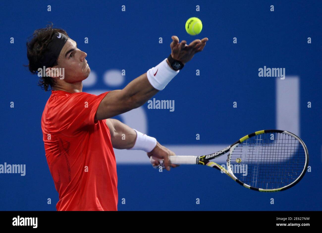 Rafael Nadal of Spain serves the ball to Roger Federer of Switzerland  during the finals of the Mubadala World Tennis Championship at the International  Tennis Complex in Zayed Sports City, Abu Dhabi