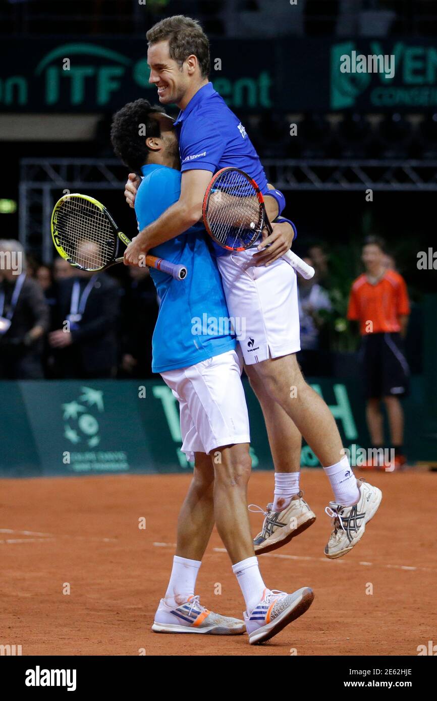 French players Jo-Wilfried Tsonga (L) and Richard Gasquet react after  defeating Australian players Lleyton Hewitt and Chris Guccione during their  Davis Cup world group first round tennis doubles match in Mouilleron-Le- Captif, Western