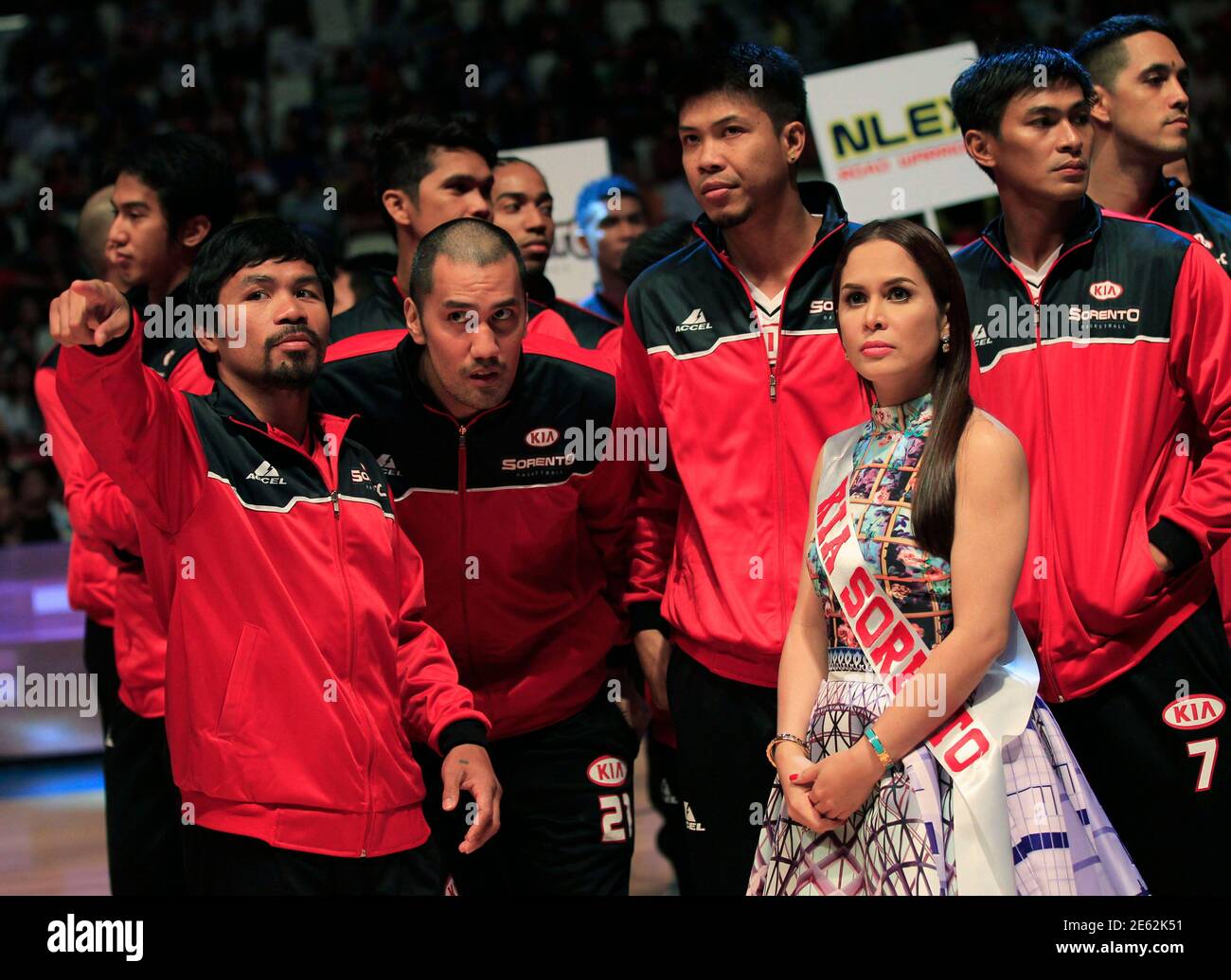 Manny Pacquiao (L), the playing coach of gesture as he joins his teammates during the opening of the 40th Season of the Philippine Basketball Association (PBA) games, against the Blackwater-Elite, in