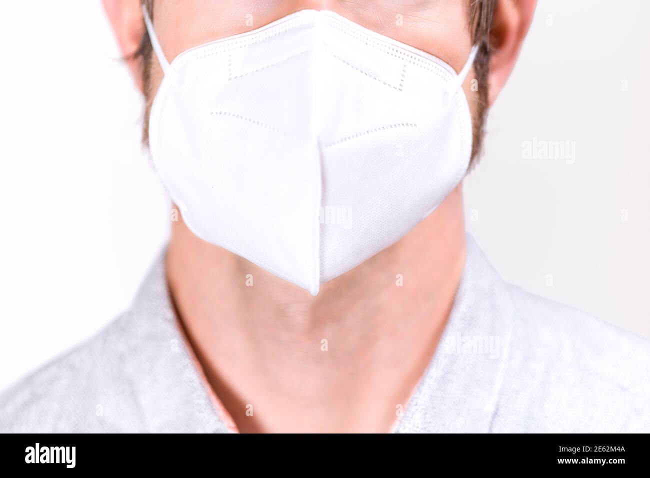Man wearing white FFP2 Face Mask - COVID protection Stock Photo