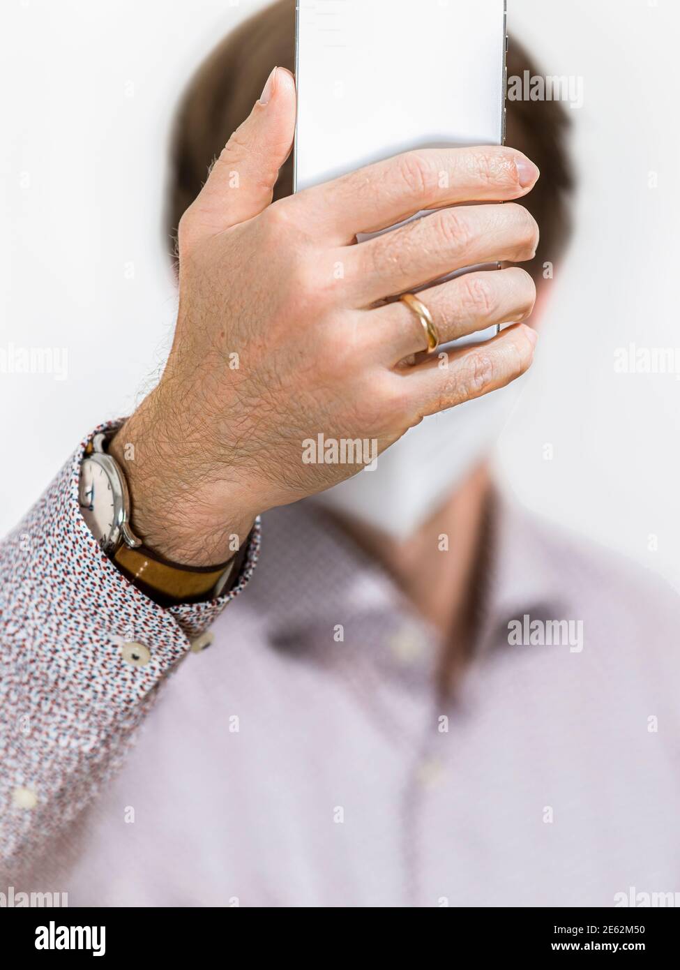 Man with facemask unlocking cellphone Stock Photo