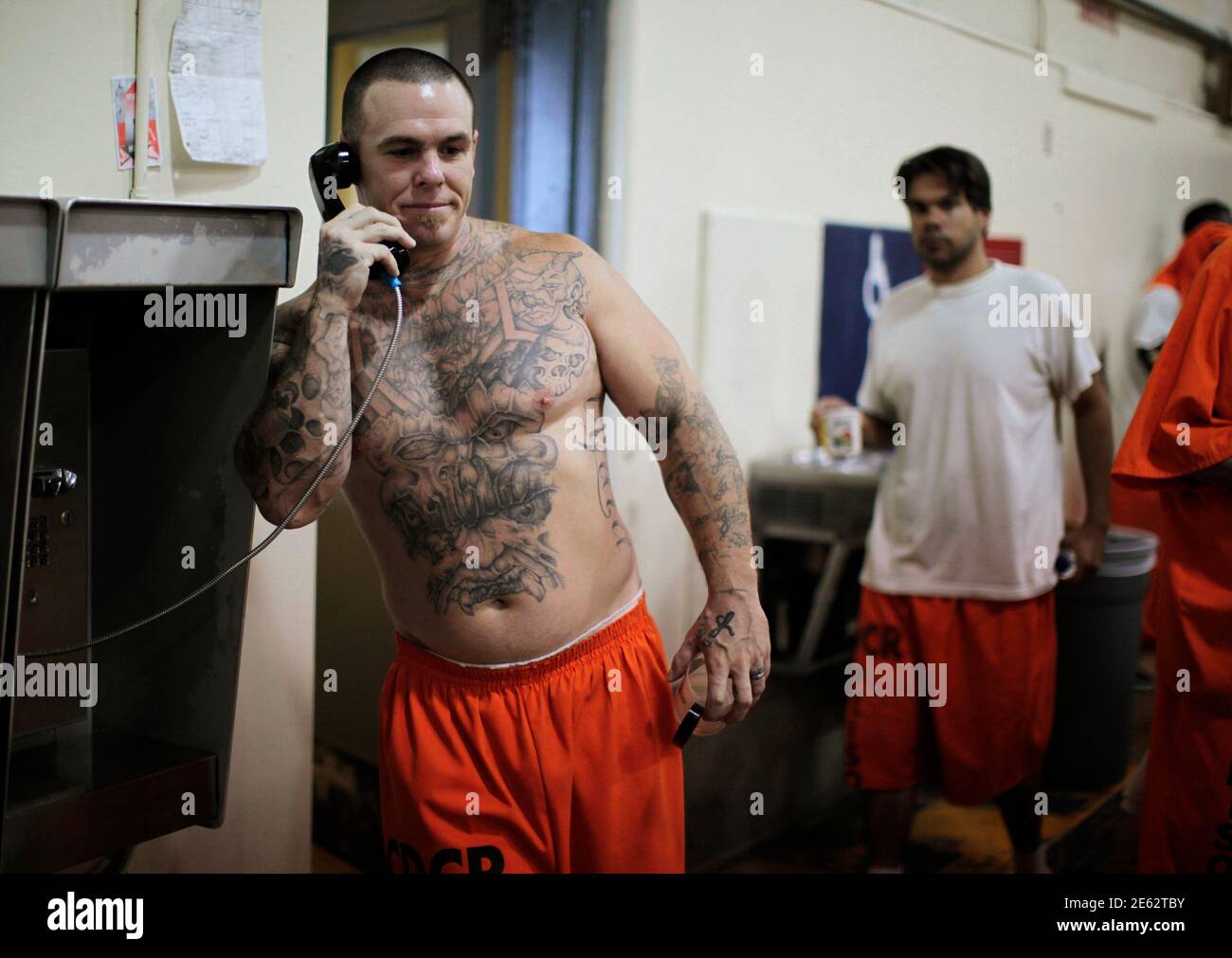 An inmate talks on the phone in a gymnasium where he is housed due to overcrowding at the California Institution for Men state prison in Chino, California, June 3, 2011. The Supreme Court has ordered California to release more than 30,000 inmates over the next two years or take other steps to ease overcrowding in its prisons to prevent 'needless suffering and death.' California's 33 adult prisons were designed to hold about 80,000 inmates and now have about 145,000. The U.S. has more than 2 million people in state and local prisons. It has long had the highest incarceration rate in the world.  Stock Photo