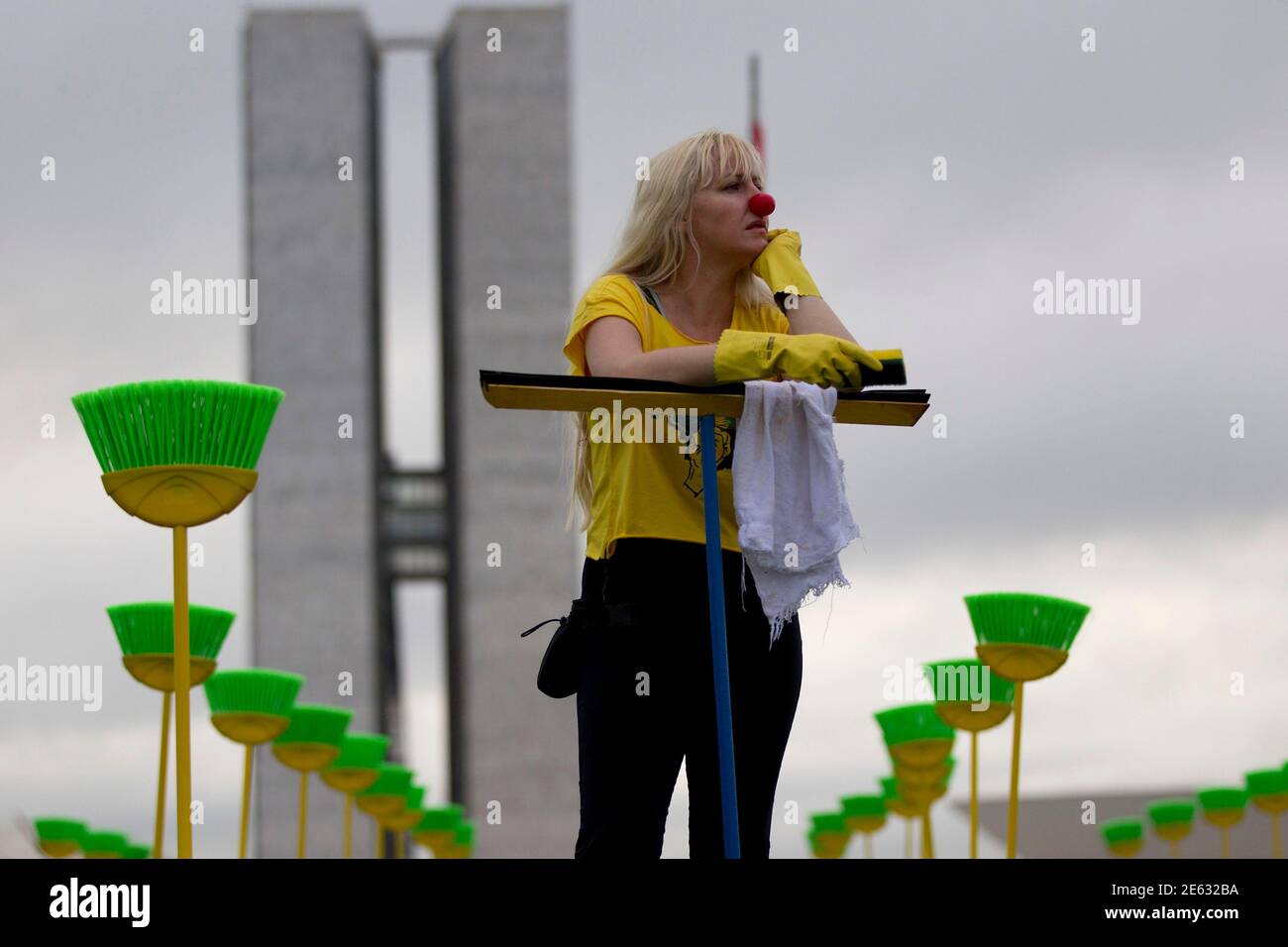 Cristia Lima, a public servant and a volunteer at the Rio de Paz (Peace Rio) Non-Governmental Organization (NGO), participates in a protest where brooms and household cleaning equipment are placed by Rio de Paz on the lawn in front of the National Congress in Brasilia January 30, 2013. The 81 cleaning kits, which represent the number of senators in the country, are placed to urge compliance with the Law of Clean Record for the election of the new President of the Brazilian Senate. REUTERS/Ueslei Marcelino (BRAZIL - Tags: POLITICS CIVIL UNREST) Stock Photo
