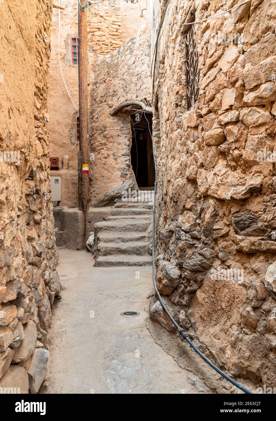 Narrow alleyway in the old mountain village Misfat Al Abriyeen in Sultanate of Oman. Stock Photo