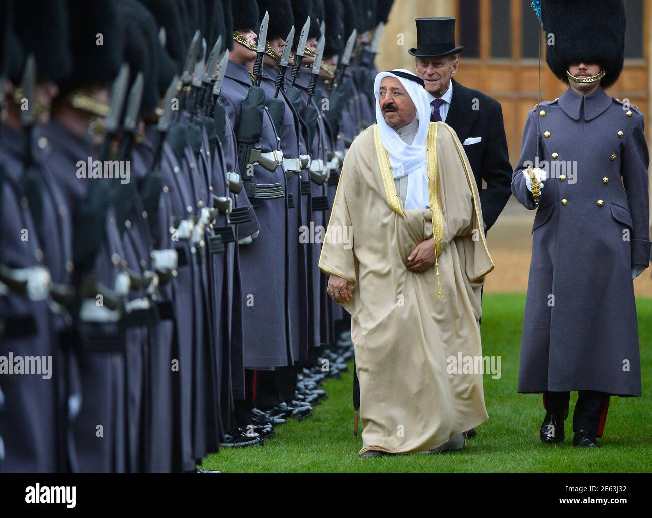 The Emir of Kuwait, Sheikh Sabah al-Ahmad al-Sabah (C), is followed by Britain's Prince Philip (2nd R) as he inspects members of the 1st Battalion Irish Guards at Windsor Castle in Windsor, southern England November 27, 2012. The Emir arrived at Windsor Castle on Tuesday for the start of a state visit to Britain.    REUTERS/Toby Melville (BRITAIN - Tags: ENTERTAINMENT POLITICS SOCIETY ROYALS) Stock Photo