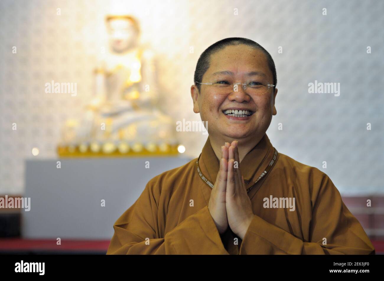 Venerable  Manchien Shih, who is in charge of the European Regional Temple, reacts at the temple in Bussy-Saint Georges, 30 km (19 miles) east of Paris June 21, 2012. The European Regional Temple, Europe's biggest Buddhist temple and the future European headquarters of the Taiwanese monastic order of Fo Guang Shan, resides in a neighbourhood, nicknamed ?the esplanade of religions? by the city?s mayor Hugues Rondeau, which is aimed at facilitating dialogue between different communities in the city. The temple, which has the capacity to host up to 1,100 devotees, will be inaugurated on Sunday be Stock Photo