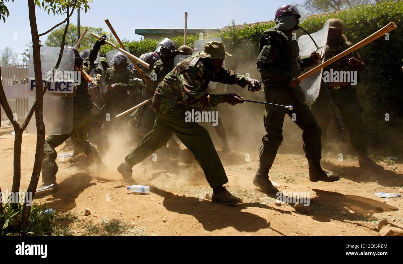 Riot policemen run to take cover after dispersing residents during protests to oust Narok county Governor Samuel Tunai in Narok, Kenya, January 26, 2015. At least seven people were injured on Monday in clashes between Kenyan police and protesters from the Maasai ethnic group who accuse a local governor of corrupt handling of tourism funds from the Maasai Mara game reserve, the Kenya Red Cross said.  REUTERS/Thomas Mukoya (KENYA - Tags: POLITICS CIVIL UNREST CRIME LAW TRAVEL) Stock Photo