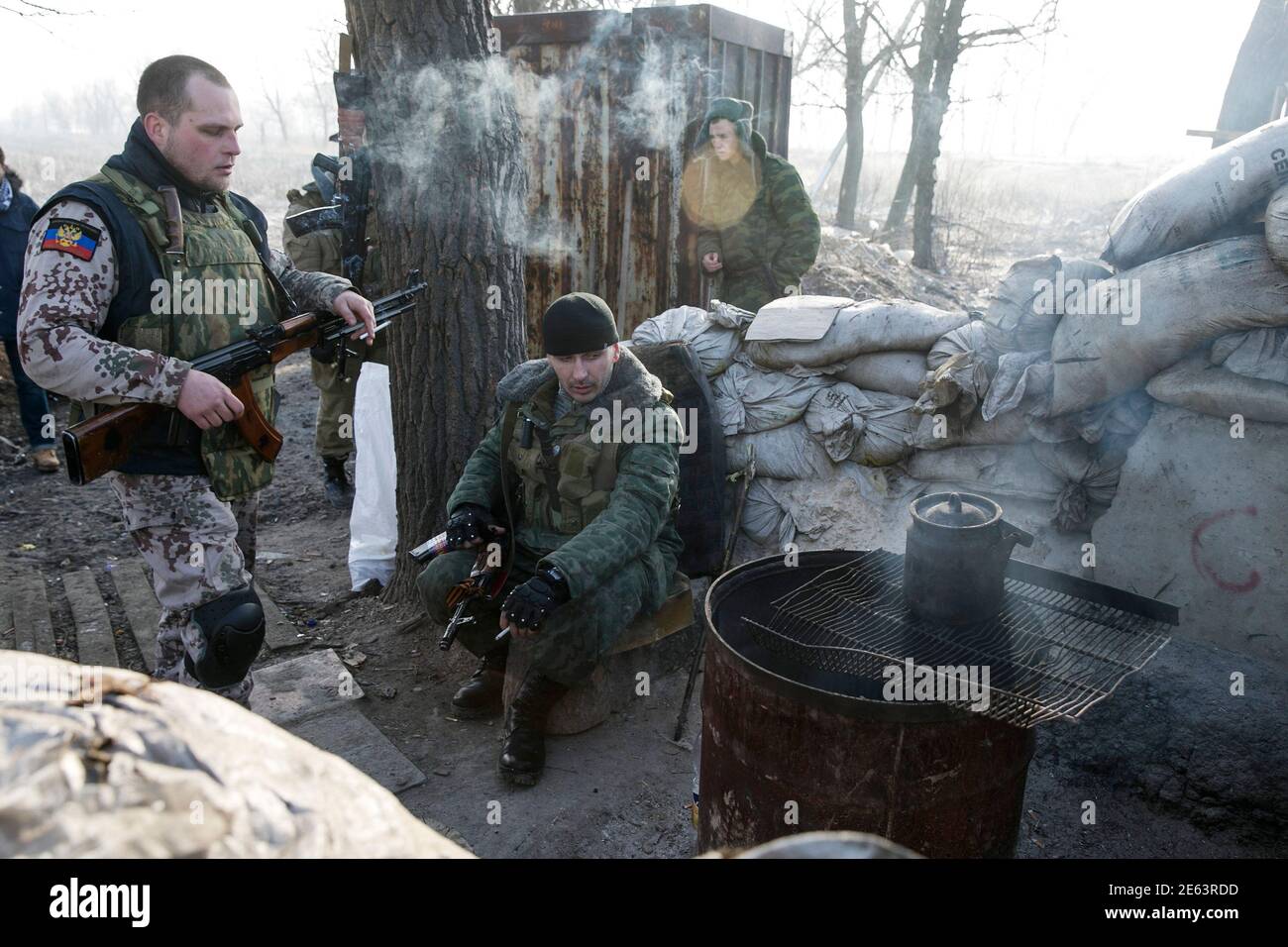 Members of the armed forces of the separatist self-proclaimed Donetsk People's Republic rest at a checkpoint near Donetsk, February 15, 2015. The Ukrainian military said on Sunday a ceasefire between government troops and pro-Russian separatists in east Ukraine is being observed 'in general' and that rebel attacks are infrequent and not widespread .REUTERS/Baz Ratner (UKRAINE - Tags: CIVIL UNREST MILITARY POLITICS CONFLICT) Stock Photo