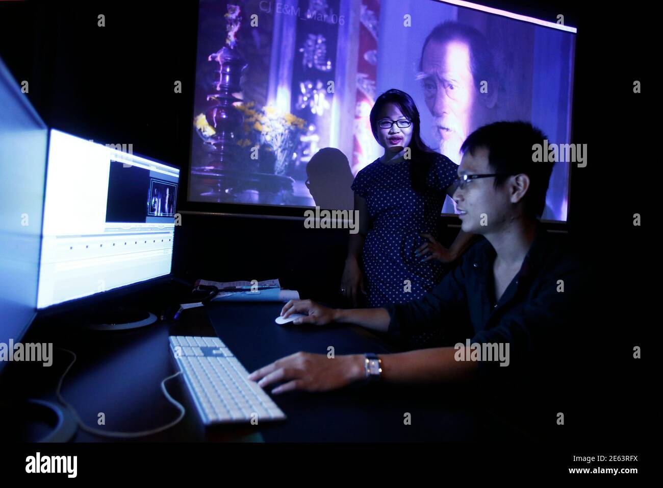 Film producer Jenni Trang Le works with an editor in her studio in Ho Chi  Minh City March 9, 2015. Jenni Trang Le has made her mark in the Vietnamese  film industry,